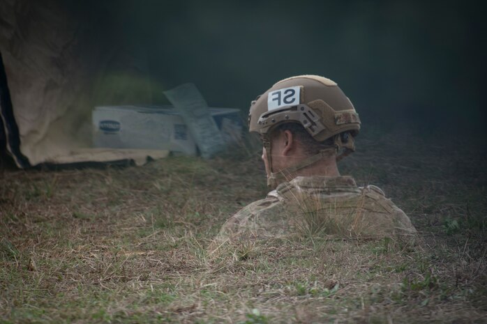 An Airman is reflected in a vehicle mirror while he heats up his MRE, (meal ready to eat), during Exercise Crescent Moon Feb. 12, 2019, at North Auxiliary Airfield in North, S.C.