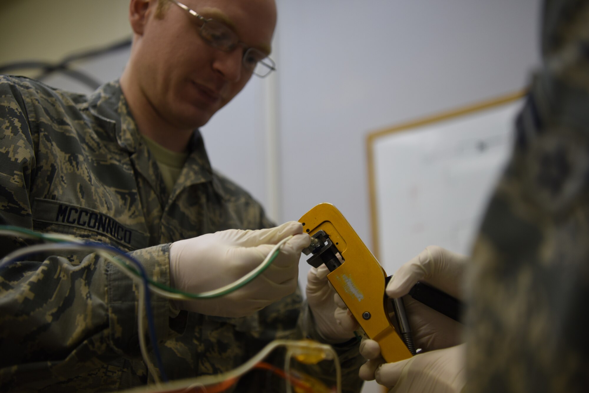 Airman 1st Class John Mcconnico and Airman 1st Class Wilfredo Hernandez Mendez, 90th Missile Maintenance Squadron Hardened Intersite Cable System technicians, train to complete a wire splice Jan. 31, 2019, at F.E. Warren Air Force Base, Wyo. The 90th MMXS HICS team is responsible to maintaining relationship with landowners, yearly inspections of the cables in the field, emergency repairs and regular upkeep of stored cables. The cables run throughout the F.E. Warren Missile Complex and are part of the communication system between Launch Control Centers and an ICBM at a Launch Facility. (U.S. Air Force photo by Senior Airman Abbigayle Williams)