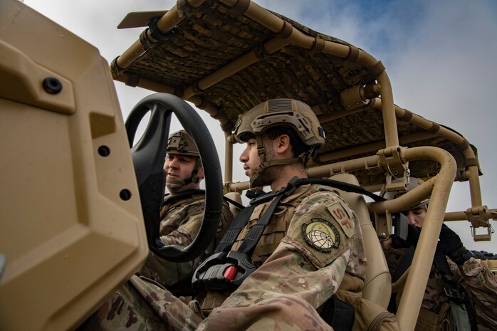 Staff Sgt. Daniel Olszewski, 621st Contingency Response Support Squadron communication operator, left, and Senior Airman Robert Bloech, 621st Contingency Response Squadron security forces member, right, prepare to drive an all-terrain vehicle during Exercise Crescent Moon Feb. 12, 2019, at North Auxiliary Airfield in North, S.C.
