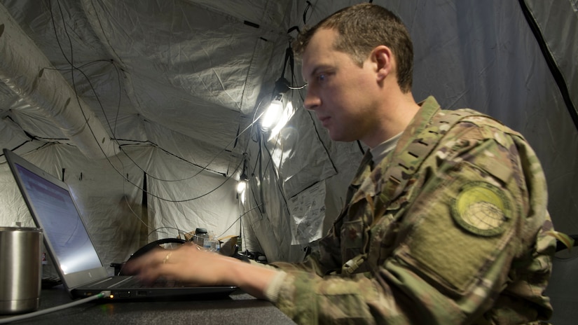 Maj. Kurt Degerlund, 621st Contingency Response Squadron pilot, works on a laptop during Exercise Crescent Moon Feb. 12, 2019, at North Auxiliary Airfield in North, S.C.