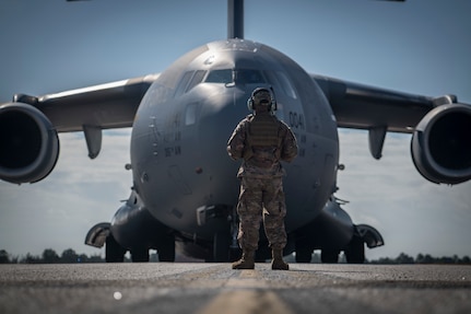 Staff Sgt. Nathaniel Ramos, 321st Contingency Response Squadron maintainer, stands guard in front of a Joint Base Charleston C-17 Globemaster III during Exercise Crescent Moon Feb. 12, 2019, at North Auxiliary Airfield in North, S.C.