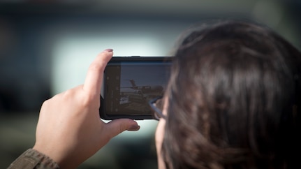 Staff Sgt. Arlene Carballido, 621st Contingency Response Squadron air traffic controller, takes a photograph of a C-17 Globemaster III during Exercise Crescent Moon Feb. 12, 2019, at North Auxiliary Airfield in North, S.C.