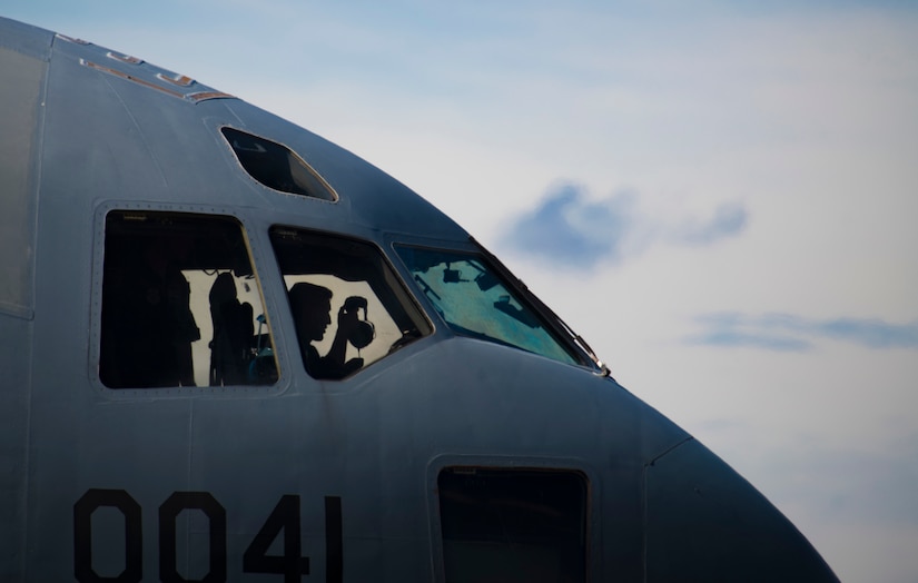 A C-17 Globemaster III pilot assigned to the 437th Airlift Wing dons his headphones during Exercise Crescent Moon Feb. 12, 2019, at North Auxiliary Airfield in North, S.C.