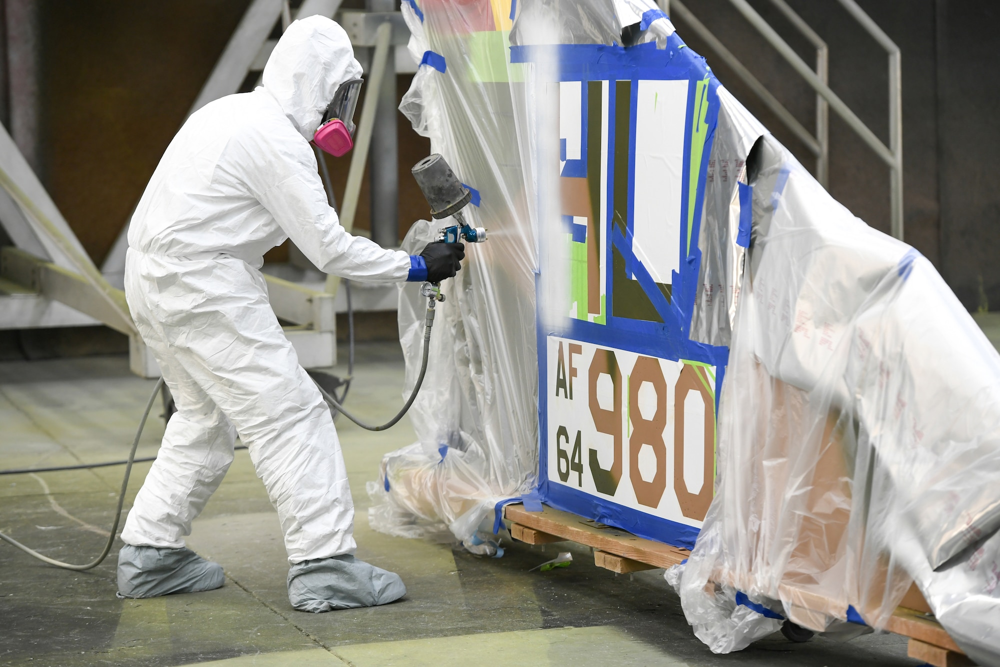 Technical Sgt. Robert Gutierrez, 388th Maintenance Squadron Corrosion/Paint Shop, paints the harvested tail of an F-4E Phantom Jan. 9, 2019. The tail was acquired for the Mature and Proven Aircraft division for display at their division office at Hill Air Force Base, Utah. The tail was painted in Vietnam-era camouflage colors in honor of the 388th Fighter Wing that flew the aircraft during that era. (U.S. Air Force photo by Cynthia Griggs)