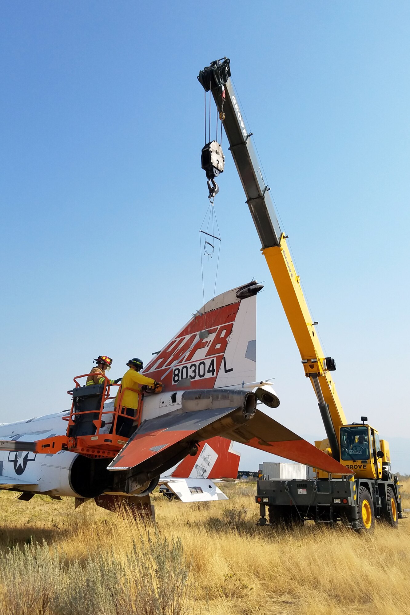 Members from 75th Civil Engineering Squadron Fire Department harvest the tail off an F-4E Phantom II Sept. 5, 2017. The Mature and Proven Aircraft division acquired the tail from the aircraft to commemorate and display at their division headquarters at Hill Air Force Base, Utah. (Courtesy photo)