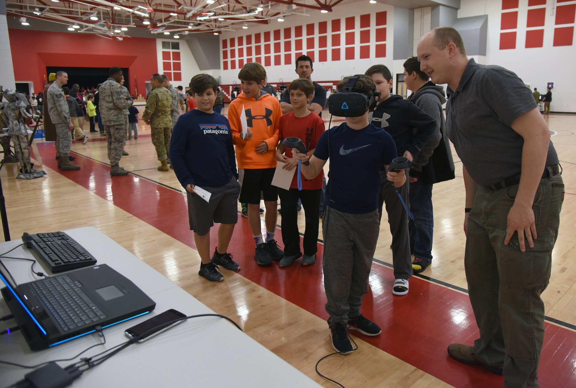 U.S. Air Force Staff Sgt. Chris Wilson, 81st Training Support Squadron instructional developer, provides a virtual reality demonstration to Biloxi school-age children during Biloxi Science, Technology, Engineering and Mathematics Night at the Biloxi Jr. High School gymnasium, Biloxi, Mississippi, Feb. 12, 2019. The entire Biloxi school district was invited to the event which promoted STEM. Six career fields from Keesler's 81st Training Wing and the 81st Training Group participated in the event. (U.S. Air Force photo by Kemberly Groue)