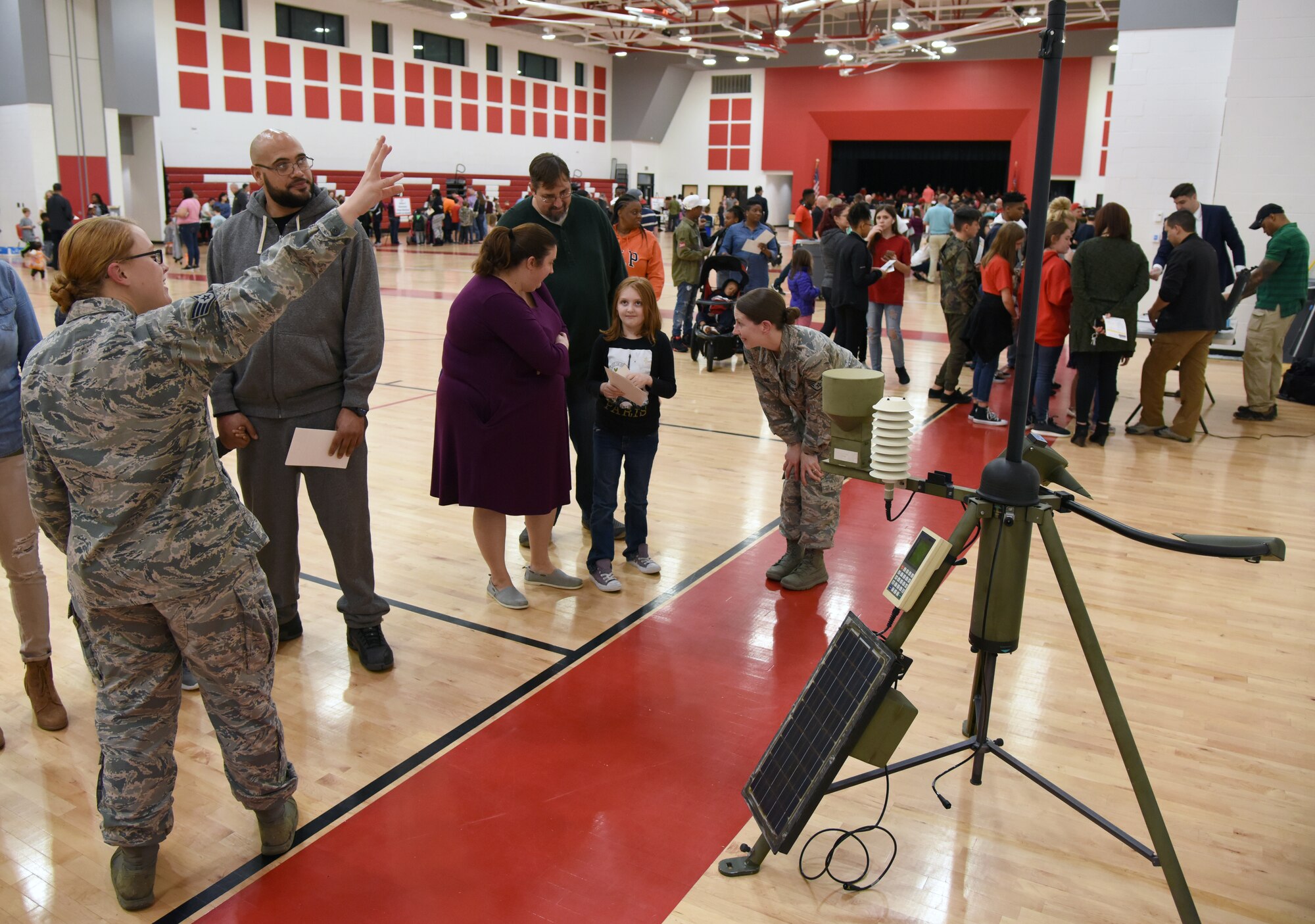 Airmen from the 335th Training Squadron weather training course briefs on deployable weather sensor equipment to Biloxi school-age children an their families during Biloxi Science, Technology, Engineering and Mathematics Night at the Biloxi Jr. High School gymnasium, Biloxi, Mississippi, Feb. 12, 2019. The entire Biloxi school district was invited to the event which promoted STEM. Six career fields from Keesler's 81st Training Wing and the 81st Training Group participated in the event. (U.S. Air Force photo by Kemberly Groue)