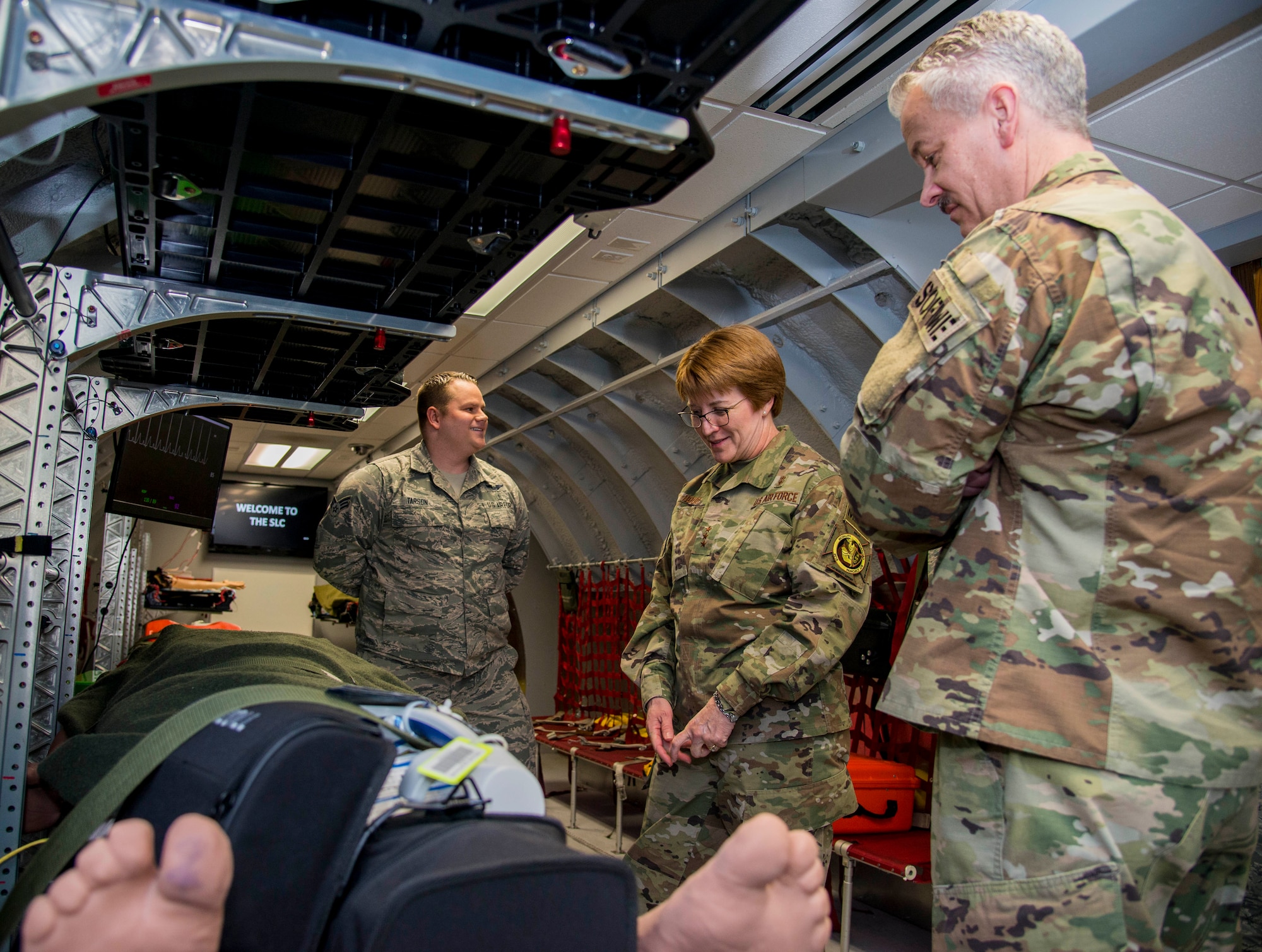 Senior Airman Zack Tarson, 375th Aeromedical Evacuation Squadron aeromedical evacuation technician, leads a tour to Lt. Gen. Dorothy Hogg, U.S. Air Force surgeon general, and Chief Master Sgt. G. Steve Cum, Chief, Medical Enlisted Force and Enlisted Corps Chief, of the Cargo Compartment Trainer located within the 375th AES at Scott Air Force Base, Illinois, Feb. 13, 2019. The trainer replicates the inside of a KC-135 Stratotanker and provides a realistically simulated clinical experience to AE crew members. (U.S. Air Force photo by Airman 1st Class Nathaniel Hudson)