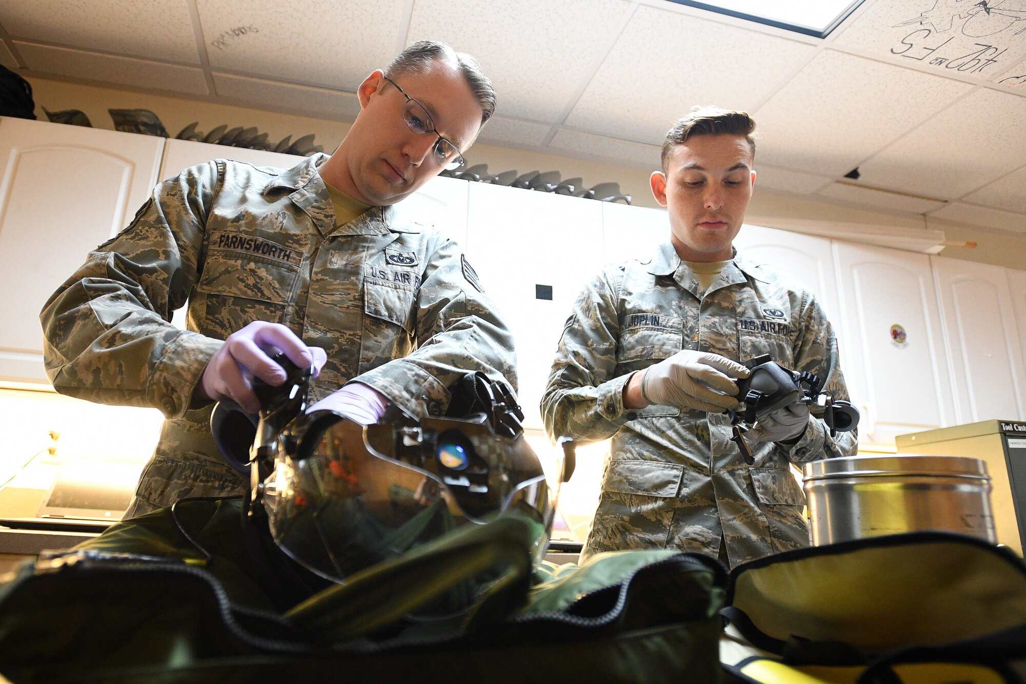 Tech. Sgt. Anthony Farnsworth (left), a reservist in the 419th Operations Support Flight, and Airman 1st Class Ryan Joplin, an active duty Airman in the 388th Operations Support Squadron, work together in the Aircrew Flight Equipment shop on flight equipment