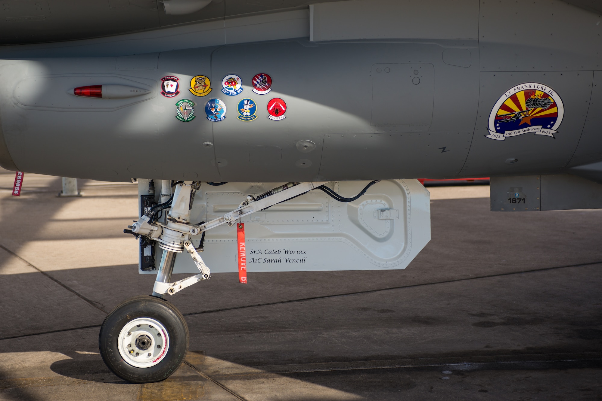 The newly painted 56th Fighter Wing F-16 Fighting Falcon flagship displays the emblems of every fighter squadron at Luke Air Force Base, Ariz. The emblems are part of a vintage paint scheme applied to the aircraft, which promotes the heritage and role the aircraft has played in the Air Force. (U.S. Air Force photo by Senior Airman Caleb Worpel
