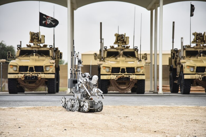 A F6A Andros robot maneuvers past three mine-resistant, ambush-protected all-terrain vehicles, also known as M-ATVs, during proficiency training at Al Dhafra Air Base, United Arab Emirates, Feb. 12, 2019. EOD Airmen are required to train for 24 hours a week to stay efficient in their craft. (U.S. Air Force photo by Senior Airman Mya M. Crosby)