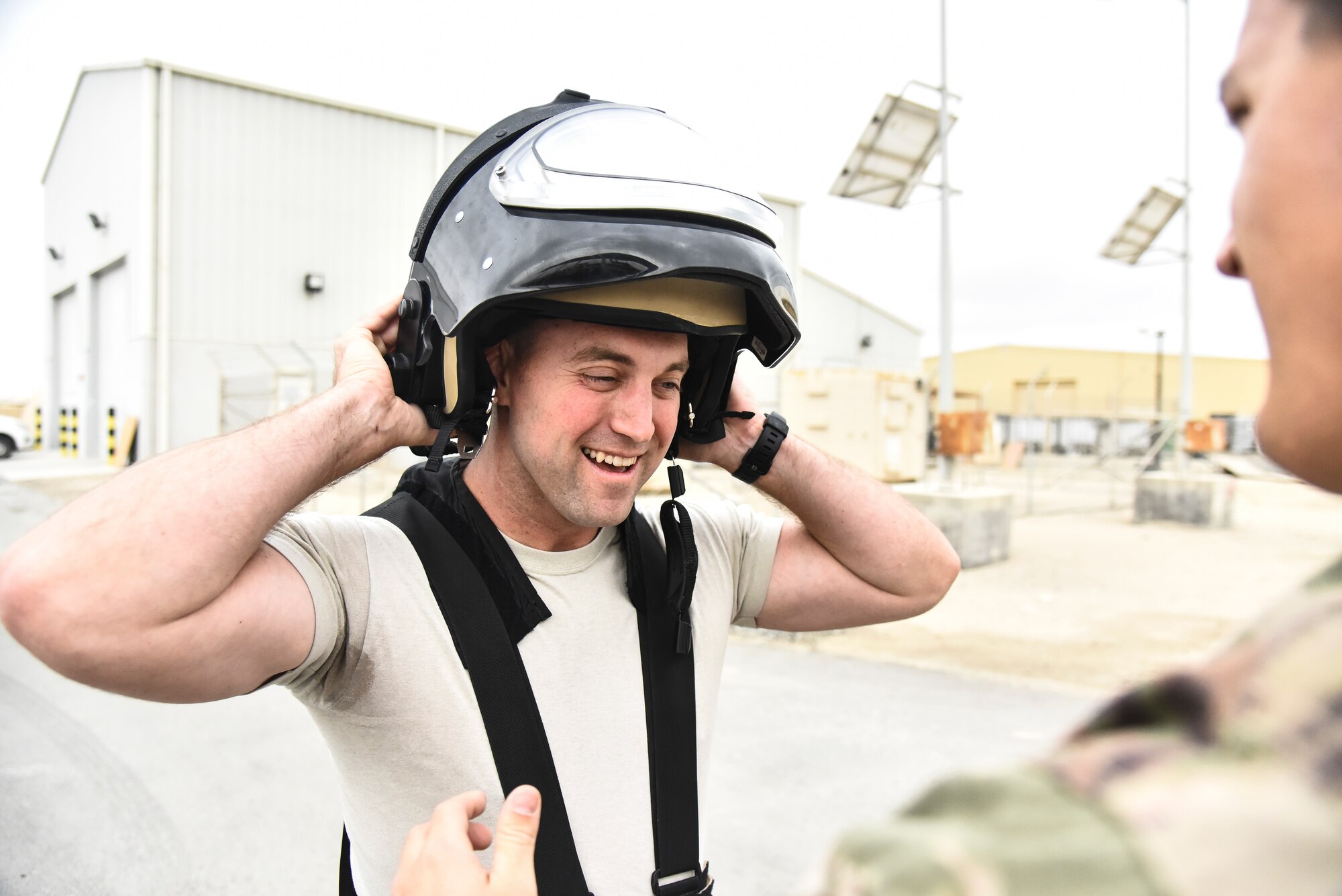 U.S. Air Force Staff Sgt. Mike Kealty, 380th Expeditionary Civil Engineer Squadron Explosive Ordnance Disposal flight EOD member, dons a bomb suit helmet during proficiency training at Al Dhafra Air Base, United Arab Emirates, Feb. 12, 2019. EOD Airmen serve as a member of base emergency response team and provide the ability to detect, monitor, evaluate, and decontaminate explosive, radioactive, chemical, or biological ordnance hazards. (U.S. Air Force photo by Senior Airman Mya M. Crosby)