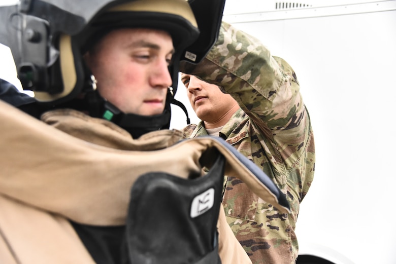 U.S. Air Force Senior Airman Zachary Pennington, 380th Expeditionary Civil Engineer Squadron Explosive
Ordnance Disposal flight EOD team member assists Staff Sgt. Mike Kealty, 380 ECES EOD team member, during proficiency training at Al Dhafra Air Base, United Arab Emirates, Feb. 12, 2019. EOD Airmen serve as a member of base emergency response team and provide the ability to detect, monitor, evaluate, and decontaminate explosive, radioactive, chemical, or biological ordnance hazards. (U.S. Air Force photo by Senior Airman Mya M. Crosby)