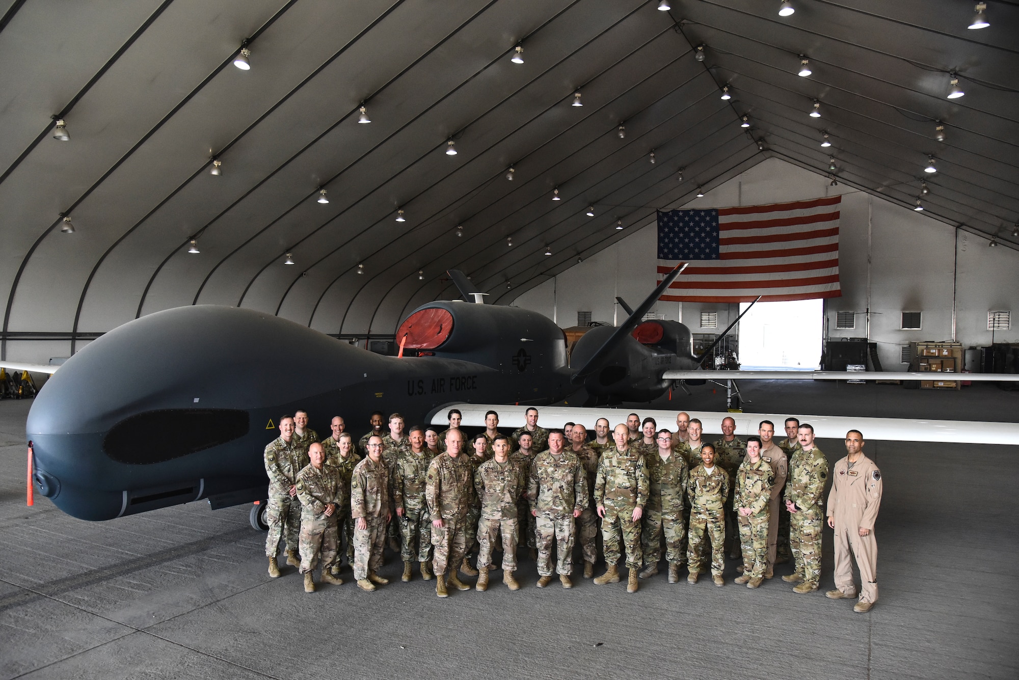 U.S. Air Force Gen. Mike Holmes, commander of Air Combat Command, and Chief Master Sgt. Frank Batten III, Air Combat Command command chief, pose for a group photo with Airmen assigned to the 380th Expeditionary Maintenance Group and 380th Expeditionary Operations Group at Al Dhafra Air Base, United Arab Emirates, Feb. 14, 2019. Holmes and Batten are charged with providing combat airpower to America’s warfighting commands, organizes, trains, equips, and maintains combat-ready forces. (U.S. Air Force photo by Senior Airman Mya M. Crosby)