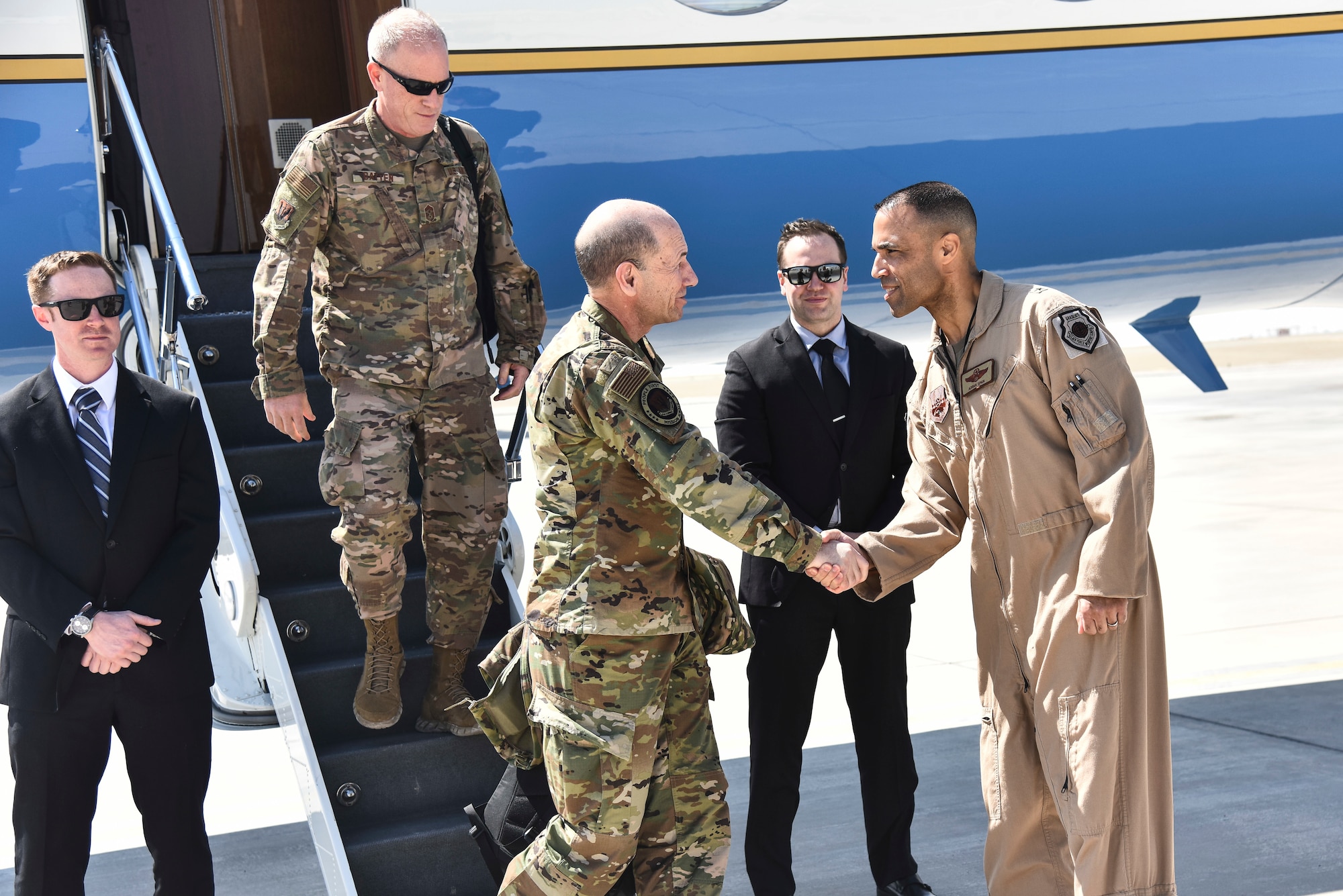U.S. Air Force Brig. Gen. Adrian Spain, 380th Air Expeditionary Wing commander, right, greets Gen. Mike Holmes, commander of Air Combat Command, upon arrival at Al Dhafra Air Base, United Arab Emirates, Feb. 14, 2019. Holmes and Chief Master Sgt. Frank Batten III, ACC command chief, were immersed in the 380th mission by getting a hands-on look at current and future operations at Al Dhafra. (U.S. Air Force photo by Senior Airman Mya M. Crosby)