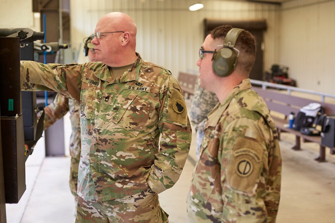 Lt. Col. Patrick Sleem instructs Sgt. 1st Class B.O. Combs on stance and body position during Service Pistol Team training.