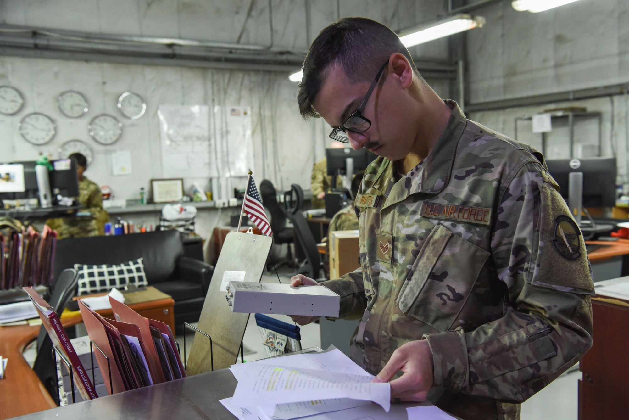 Senior Airman Steven Paskaitis, 380th Expeditionary Logistics Readiness Squadron equipment liaison, inspects turned in computer equipment inside the Desert Depot at Al Dhafra Air Base, United Arab Emirates, Feb. 11, 2019.