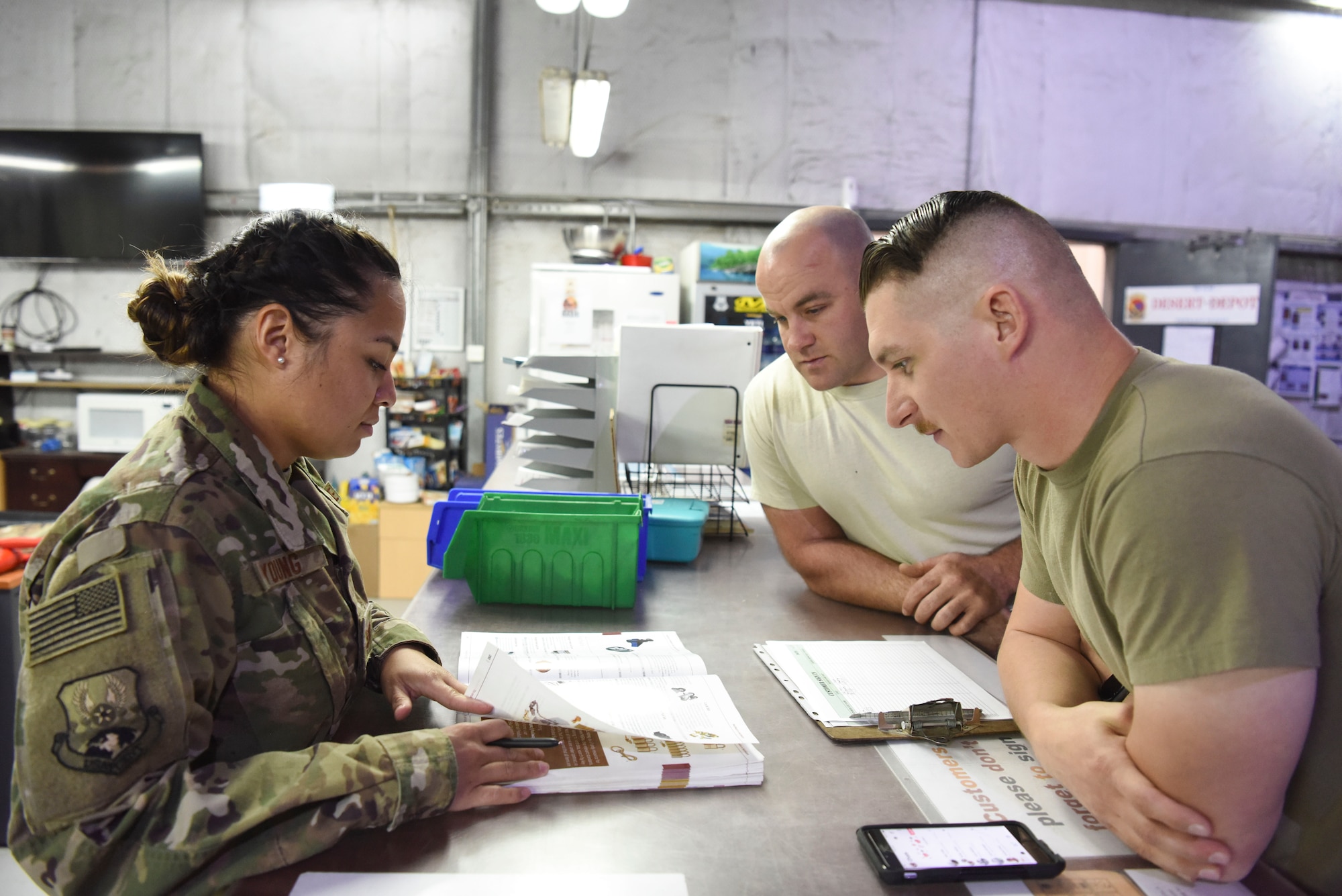 Tech. Sgt. Maxima Young, 380th Expeditionary Logistics Readiness Squadron desert depot NCOIC, assists customers with ordering supplies at Al Dhafra Air Base, United Arab Emirates, Feb. 11, 2019.