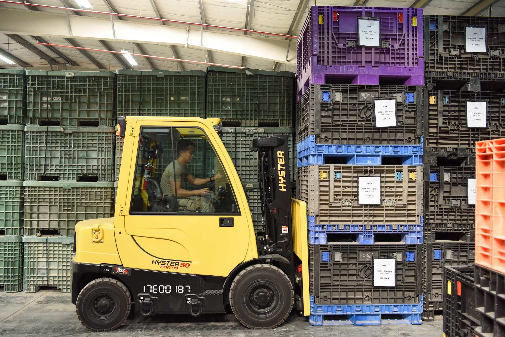 Tech. Sgt. Caresia Baldwin, 380th Expeditionary Staff Sgt. Karl Santos, 380th Expeditionary Logistics Readiness Squadron IPE supervisor, uses a forklift to reorganize containers in the equipment accountability office at Al Dhafra Air Base, United Arab Emirates, Feb. 11, 2019.