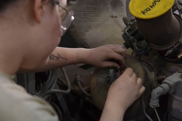 Airman 1st Class Sarah Derringer, 380th Expeditionary Maintenance Squadron Aerospace Ground Equipment technician, applies safety wire to the combustion can of a Dash 60 generator, Feb. 11, 2019, at Al Dhafra Air Base, United Arab Emirates.