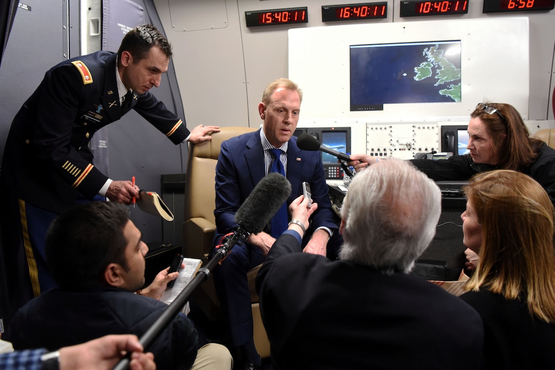 Acting Defense Secretary Patrick M. Shanahan talks to reporters on the flight home from Munich, Germany