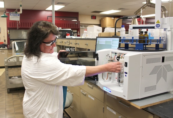 Penny Miller, organic analyst, performs maintenance on the organic carbon analyzer in the Chemical Lab at Arnold Air Force Base. Miller and others working in the Chemical and Metallurgical lab at Arnold Air Force Base support facilities base wide by helping tests stay on schedule, preventing equipment failures and keeping AEDC team members safe. (U.S. Air Force photo by Deidre Ortiz)