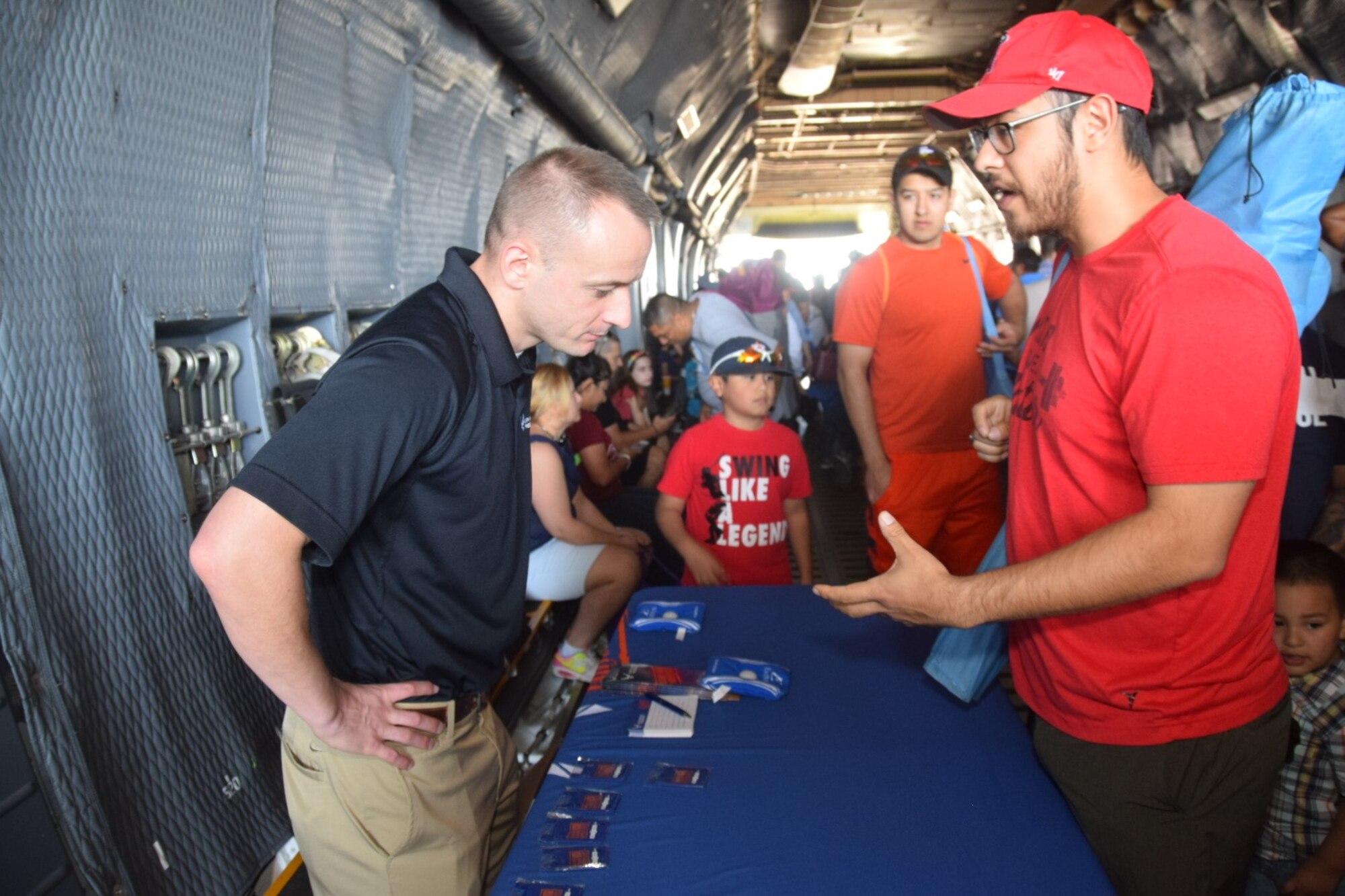 A recruiter from the 433rd Airlift Wing at Joint Base San Antonio-Lackland, Texas talks to an air show attendee at the Washington’s Birthday Celebration Association Stars and Stripes Air Show Spectacular at the Laredo International Airport in Laredo, Texas Feb. 17, 2019.