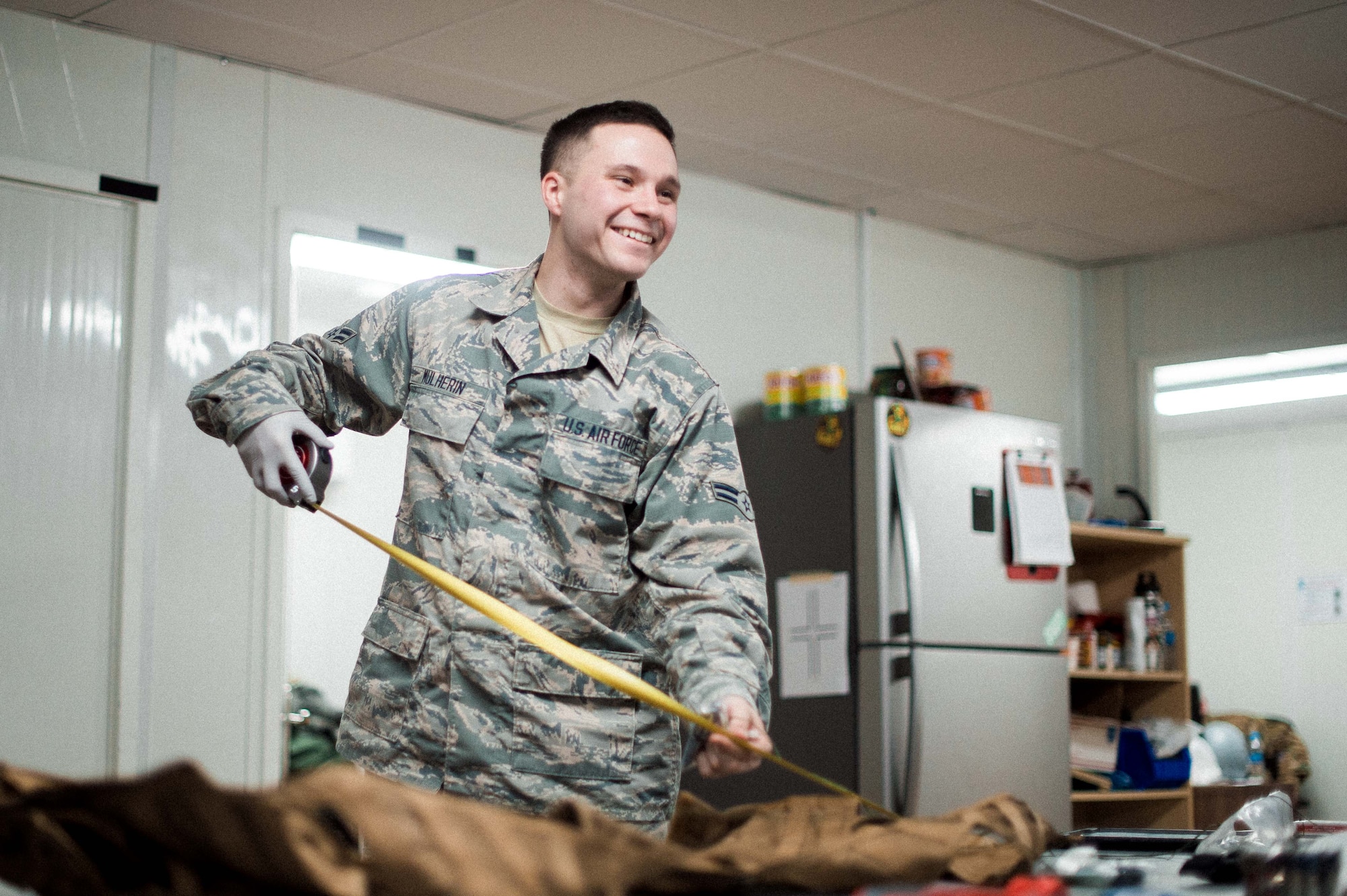 U.S. Air Force Airman 1st Class Michael Mulherin, 493rd EFS aircrew flight equipment apprentice, measures a vest February 14, 2019 in Southwest Asia. The AFE shop works around the clock to ensure an aircrew member’s daily equipment, which includes G-suits, night vision goggles, harnesses, helmets and oxygen masks, is ready to go at a moment’s notice. (U.S. Air Force photo by Staff Sgt. Delano)