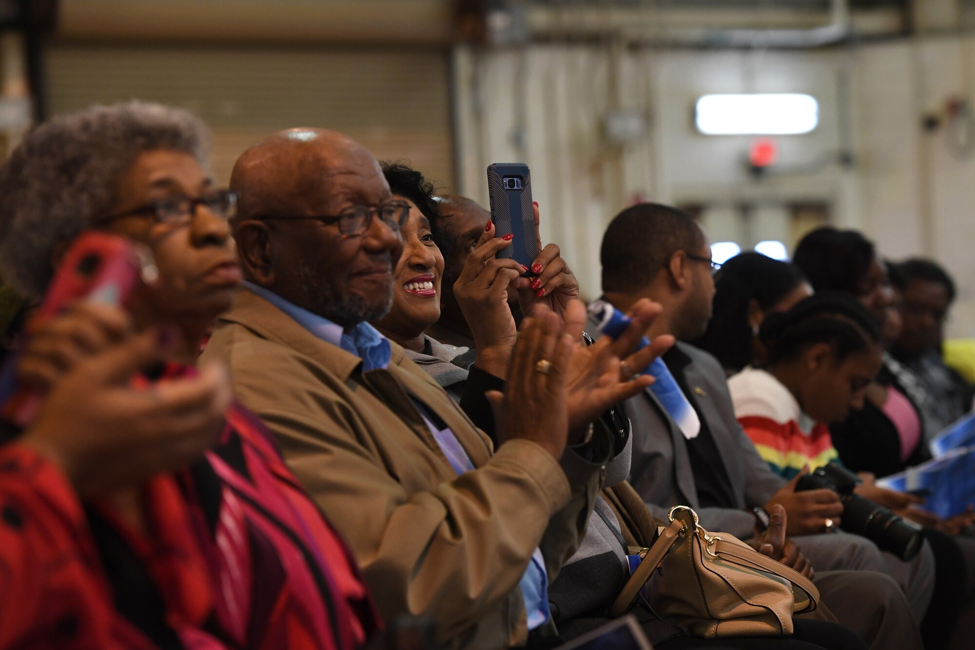Family and friends smile and applaud during U.S. Air Force Brig. Gen. Clarence Ervin’s retirement ceremony at the North Carolina Air National Guard Base (NCANG), Charlotte Douglas International Airport, Feb. 09, 2019. Family, friends and guard members gathered to celebrate the retirement of Gen. Ervin, Chief of Staff for the NCANG, after serving in the military for 37 years.