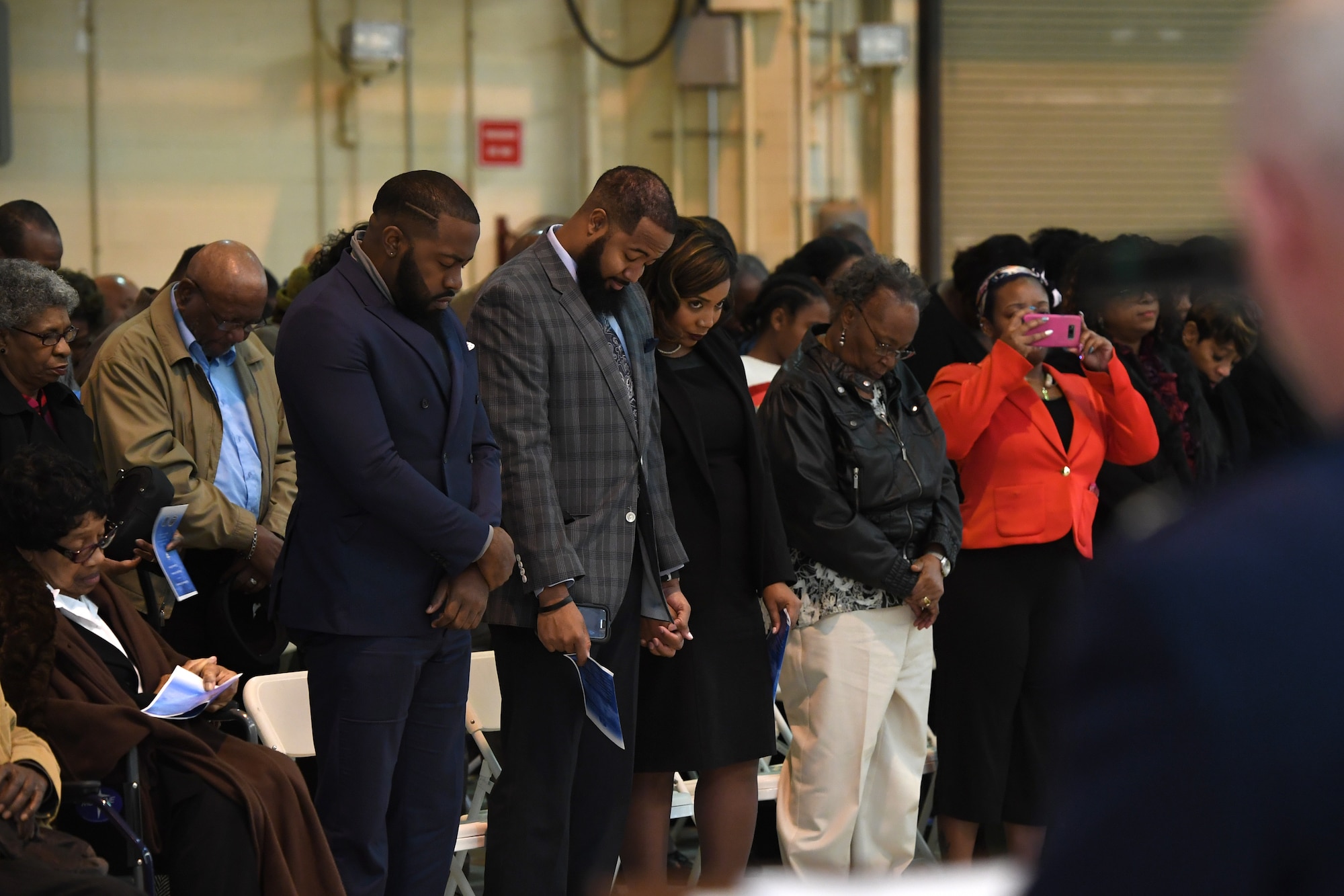 Family and friends bow their heads as U.S. Air Force Lt. Col. Jeffrey Kidd, 145th Airlift Wing Chaplain, delivers the benediction during Brig. Gen. Clarence Ervin’s retirement ceremony at the North Carolina Air National Guard Base (NCANG), Charlotte Douglas International Airport, Feb. 09, 2019. Family, friends and guard members gathered to celebrate the retirement of Gen. Ervin, Chief of Staff for the NCANG, after serving in the military for 37 years.