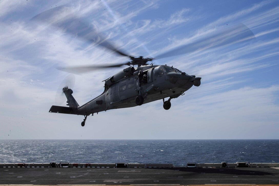 An MH-60S Seahawk, carrying cargo, prepares to land on the flight deck of the Wasp-class amphibious assault ship USS Kearsarge. Aircraft routinely transport 22nd Marine Expeditionary Unit personnel, mail and cargo to the Kearsarge. Marines and Sailors with the 22nd MEU and Kearsarge Amphibious Ready Group are deployed to the 5th Fleet area of operations in support of naval operations to ensure maritime stability and security in the Central Region, connecting the Mediterranean and the Pacific through the western Indian Ocean and three strategic choke points. (U.S. Marine Corps photo by Lance Cpl. Tawanya Norwood)