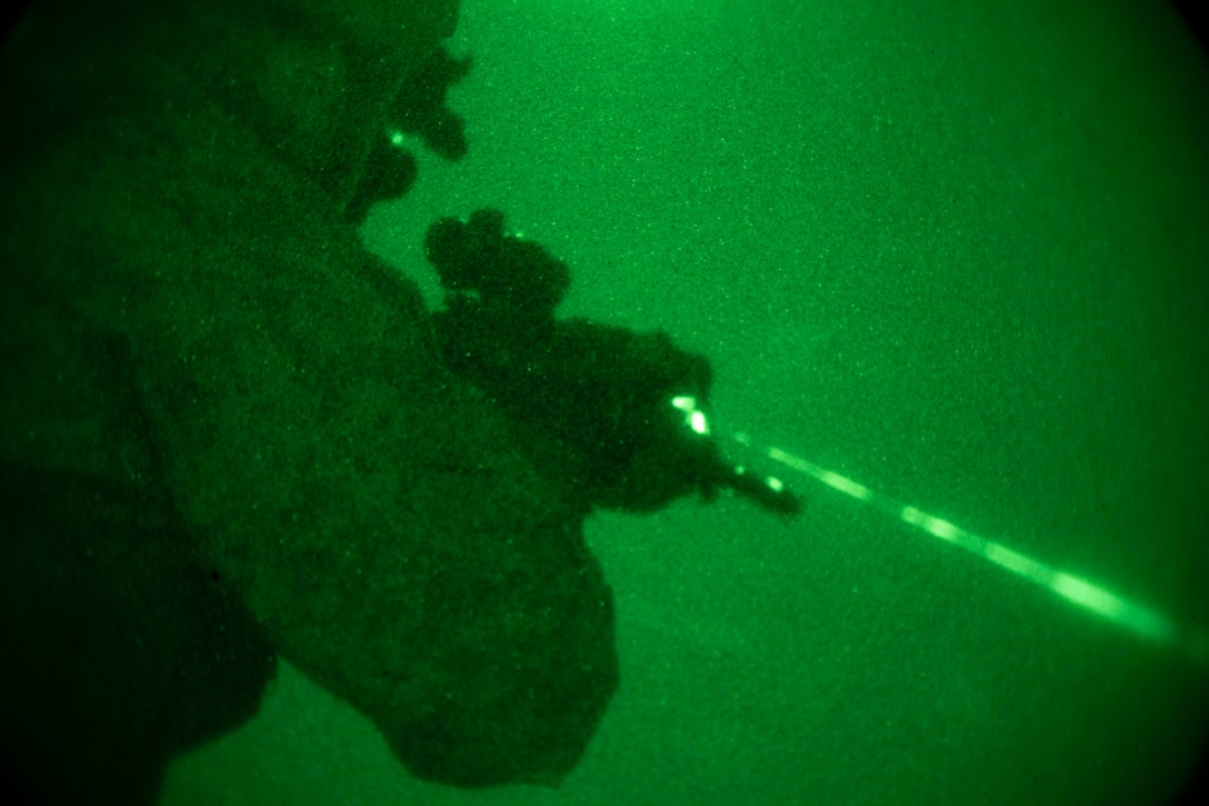 An infantry Marine, with the 22nd Marine Expeditionary Unit, aims at his target during a night deck shoot on the flight deck of the Whidbey Island-class dock landing ship USS Fort McHenry. The Marines are with Battalion Landing Team 1st Battalion, 2nd Marine Regiment and performed a night deck shoot to maintain combat readiness. Marines and Sailors with the 22nd MEU and Kearsarge Amphibious Ready Group are currently deployed to the U.S. 5th Fleet area of operations in support of naval operations to ensure maritime stability and security in the Central Region, connecting the Mediterranean and the Pacific through the western Indian Ocean and three strategic choke points.