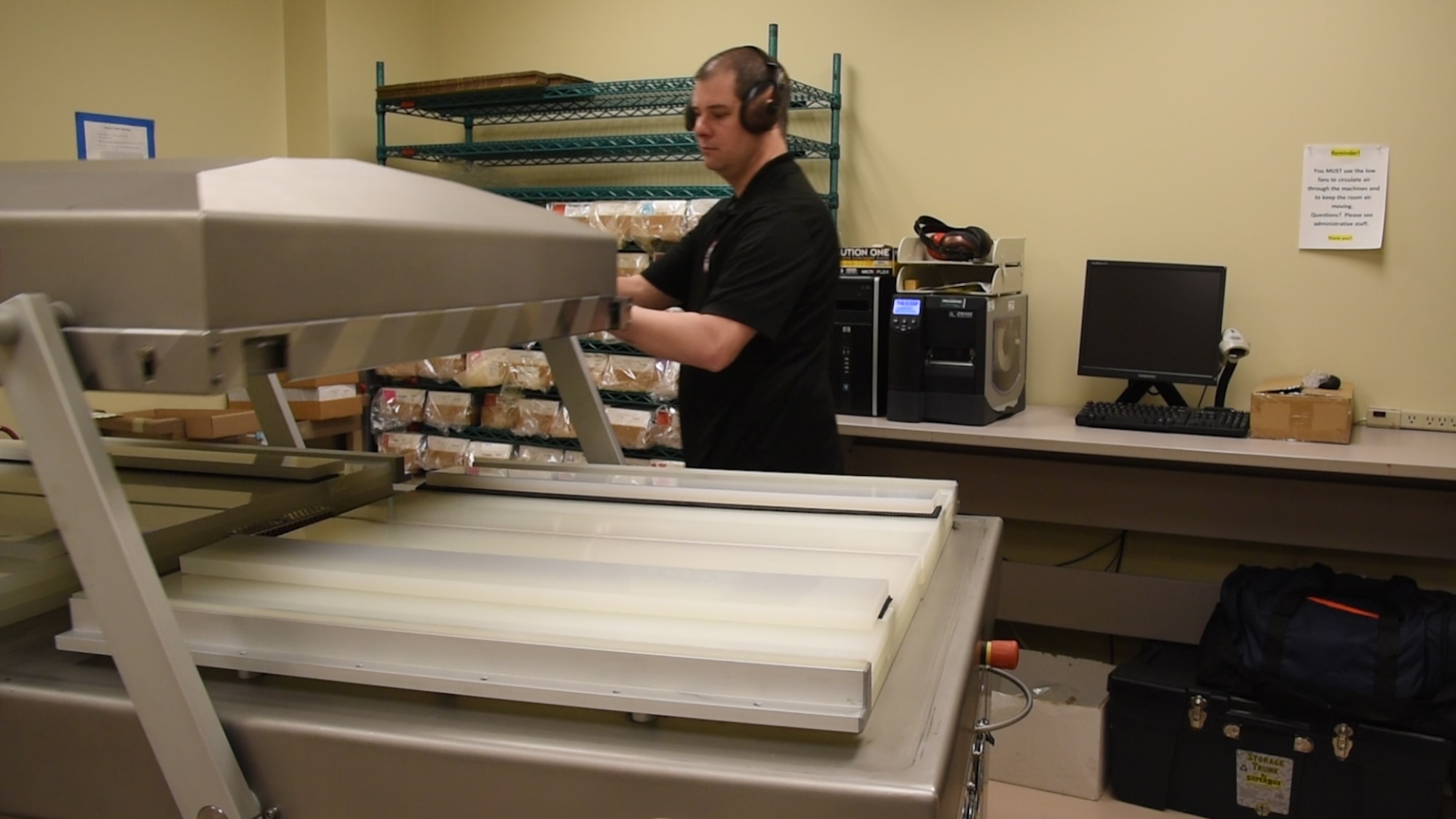 Chris Karashowsky, Armed Forces Medical Examiner System (AFMES) DNA specimen processor,, prepares a machine used to vacuum seal blood stain cards at the Armed Forces Repository of Specimen Samples for the Identification of Remains (AFRSSIR) on Dover Air Force Base, Del., Jan. 30, 2019. By sealing the cards, AFRSSIR ensures all of the samples will be preserved for 50 years, as required by AFRSSIR’s regulations. (U.S. Air Force Photo by Senior Airman Dedan D. Dials)