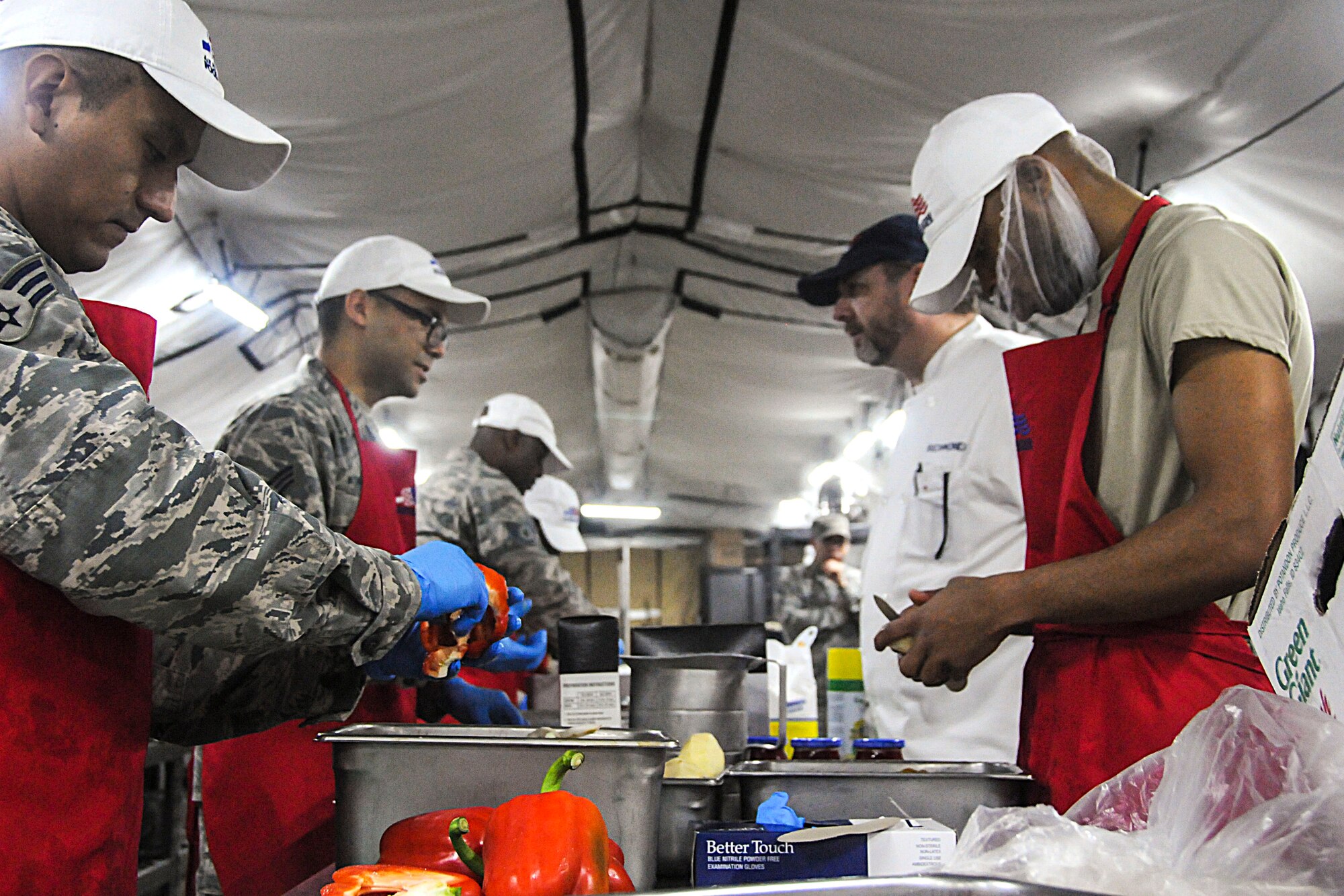 A judge watches meal preparation during this year's Hennessy competition held at the Force Support Silver Flag training facility on Dobbins Air Reserve Base Feb. 9-12. Each year a trophy is awarded to teams representing the best food service programs in the Air Force and is based on the entire scope of an installation's food service program. (U.S. Air Force photo/Senior Airman Justin Clayvon)