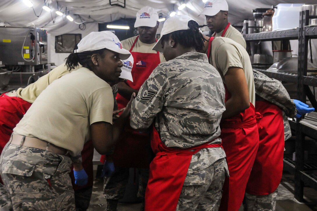 A group of participants rally during this year's Hennessy competition held at the Force Support Silver Flag training facility on Dobbins Air Reserve Base Feb. 9-12. Each year a trophy is awarded to teams representing the best food service programs in the Air Force and is based on the entire scope of an installation's food service program. (U.S. Air Force photo/Senior Airman Justin Clayvon)