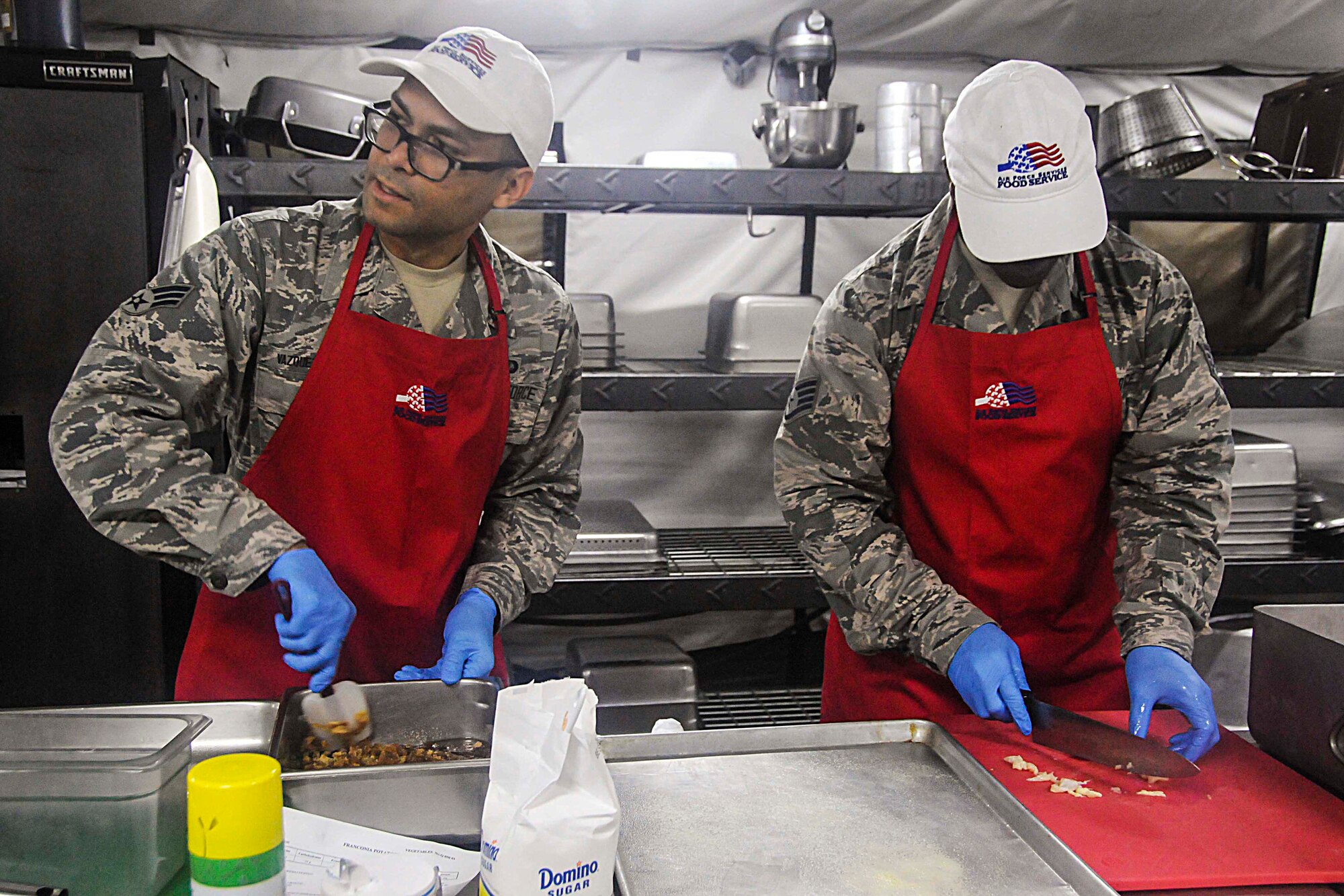 Participants prepare a meal during this year's Hennessy competition held at the Force Support Silver Flag training facility on Dobbins Air Reserve Base Feb. 9-12. Each year a trophy is awarded to teams representing the best food service programs in the Air Force and is based on the entire scope of an installation's food service program. (U.S. Air Force photo/Senior Airman Justin Clayvon)