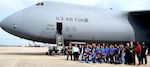 Benjamin O. Davis High School Air Force Air Force Junior Reserve Officer Training Corps students and chaperones from Aldine, Texas, and 68th Airlift Squadron air crew personnel, take a moment after a tour of a C-5M Super Galaxy Feb. 15 at Joint Base San Antonio-Lackland.