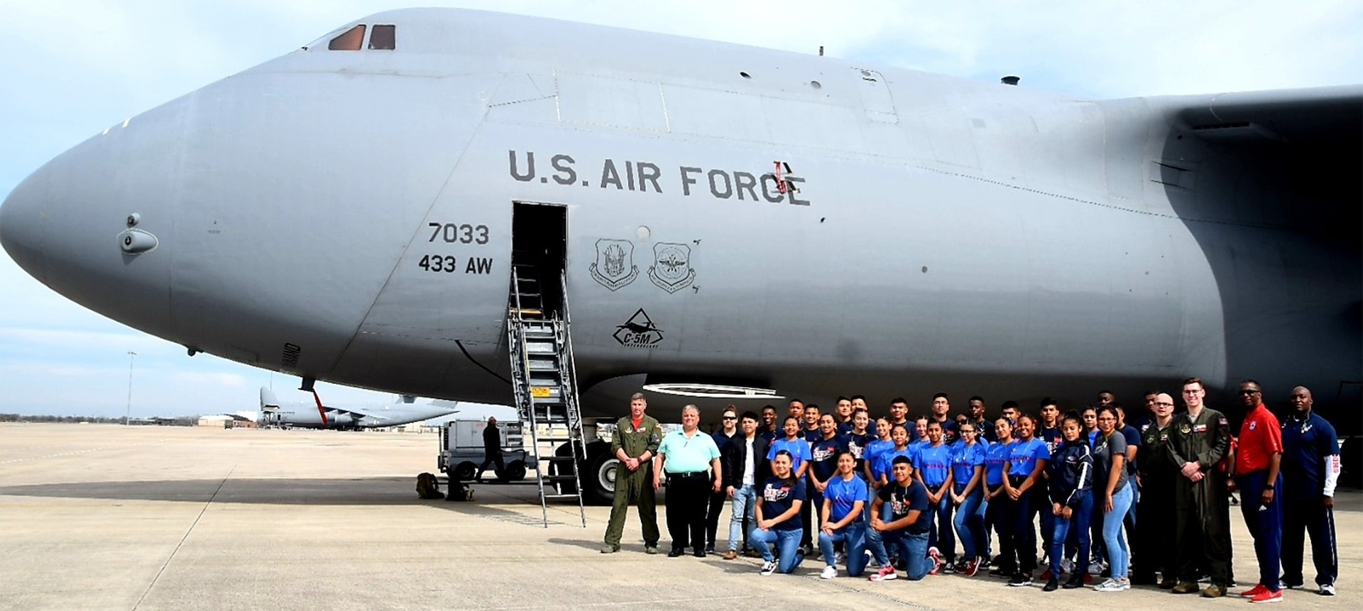 Benjamin O. Davis High School Air Force Air Force Junior Reserve Officer Training Corps students and chaperones from Aldine, Texas, and 68th Airlift Squadron air crew personnel, take a moment after a tour of a C-5M Super Galaxy Feb. 15 at Joint Base San Antonio-Lackland.