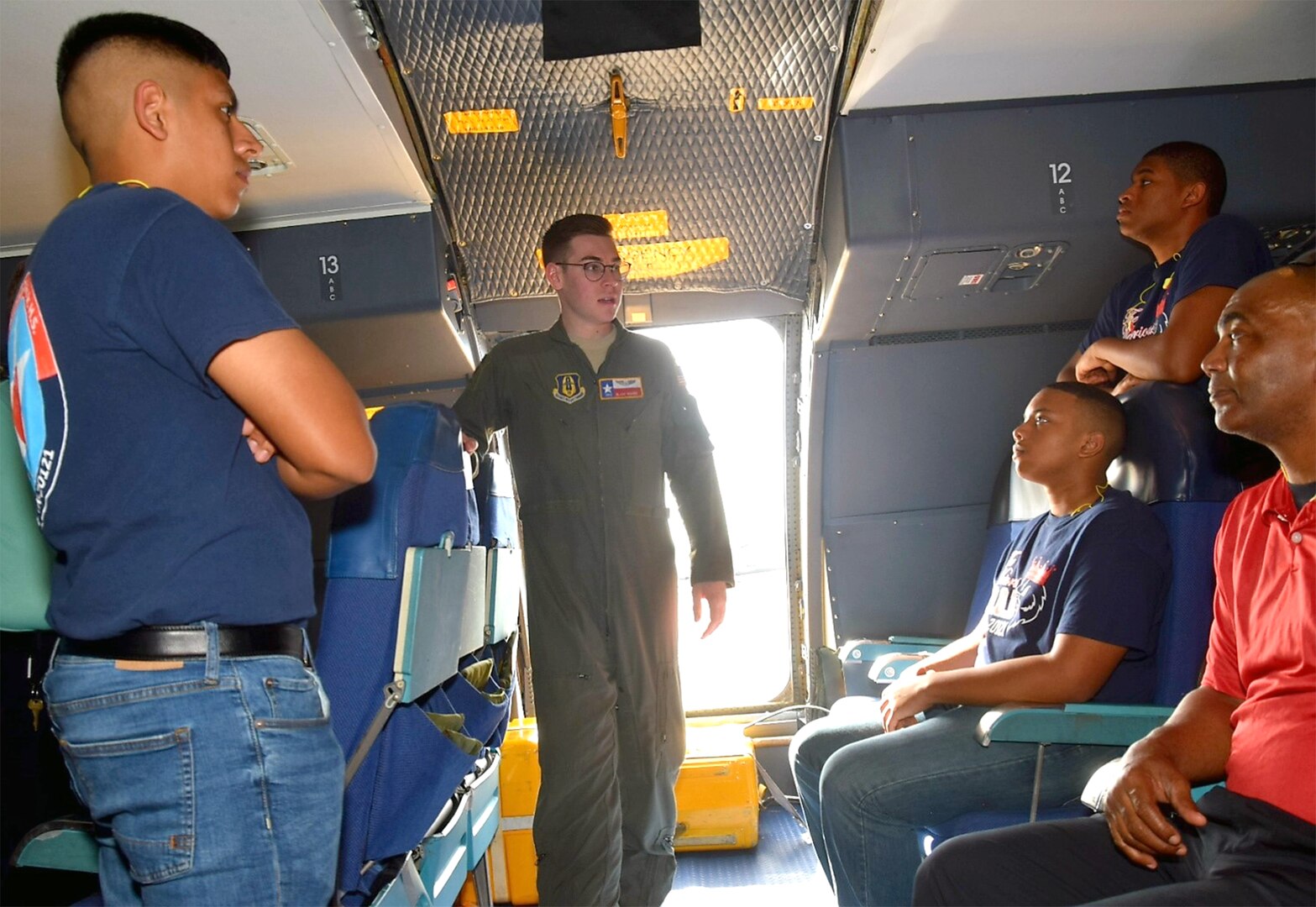 Senior Airman Blake Moore, 68th Airlift Squadron loadmaster, talks about his duties to Benjamin O. Davis High School Air Force Air Force Junior Reserve Officer Training Corps cadets from Aldine, Texas, Feb. 15 at Joint Base San Antonio-Lackland. Moore went on to explain how a loadmaster takes care of cargo and passengers on the aircraft during missions.