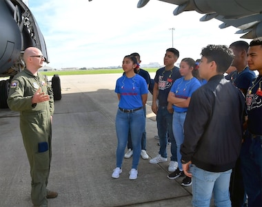 Staff Sgt. Michael Indo,68th Airlift Squadron flight engineer, explains his roles and responsibilities to Benjamin O. Davis High School Air Force Air Force Junior Reserve Officer Training Corps cadets from Aldine, Texas Feb.15 at Joint Base San Antonio-Lackland. The 33 students and five chaperones from a Houston suburb, received a tour of the C-5M Super Galaxy and had lunch at an Air Force dining facility.