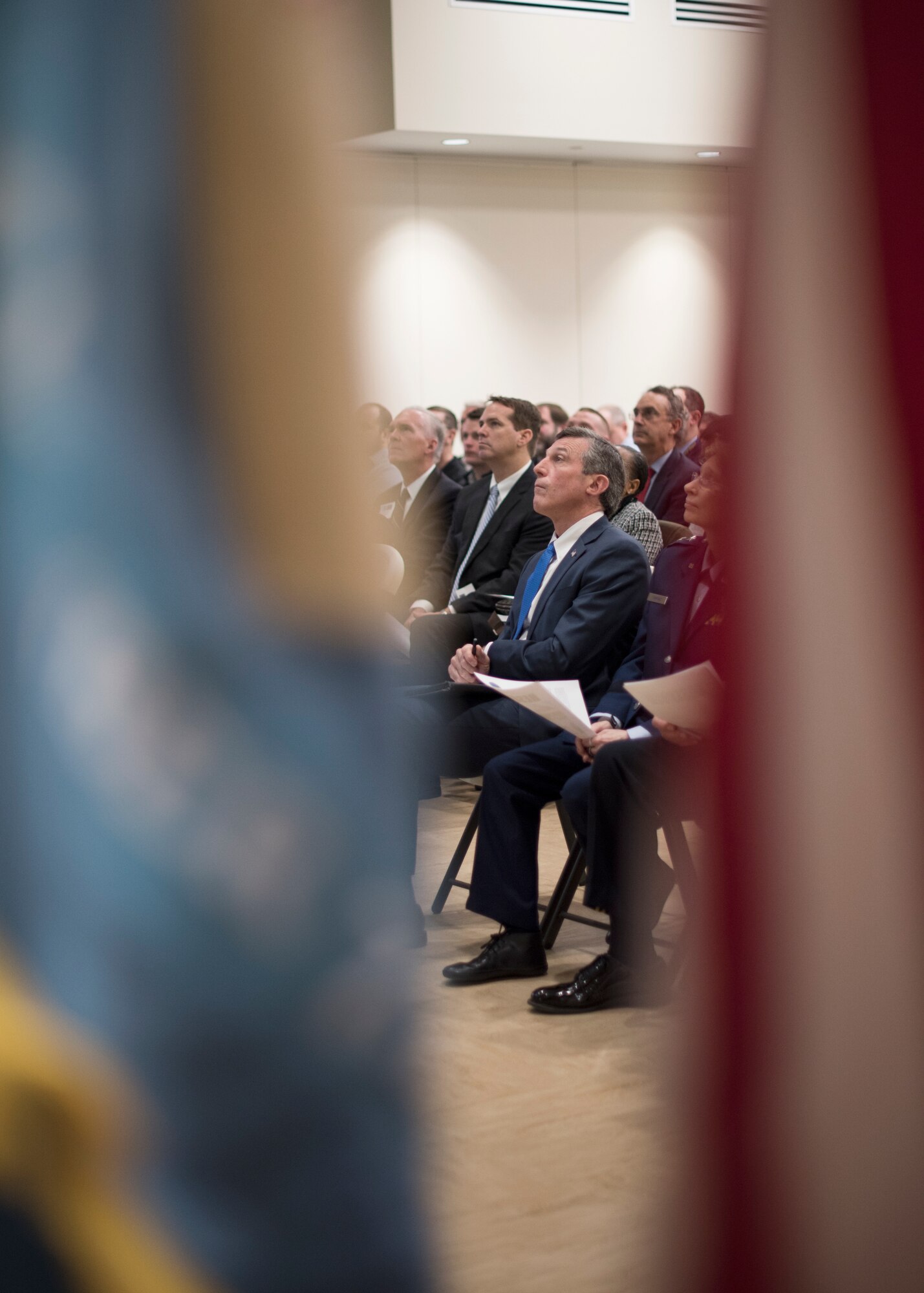 Delaware Governor John Carney watches a Year in Review video during the State of the Guard Event at Joint Force Headquarters, New Castle, Del., Feb. 15, 2019. In addition to the Chambers of Commerce, Gov. Carney attended the event and addressed the attendees by thanking them for supporting the DNG. (U.S. Air National Guard photo by Senior Airman Katherine Miller)