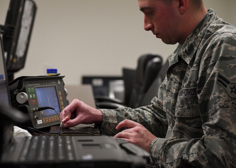 U.S. Air Force Airman 1st Class Branden Alderiso, 1st Maintenance Squadron non-destructive inspection journeyman uses ultrasonic test equipment at Joint Base Langley-Eustis, Virginia, Feb. 15, 2019.