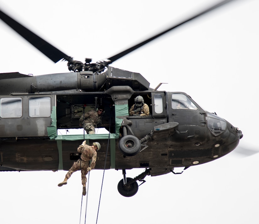 Air Assault students practice rappelling out of a Black Hawk helicopter on day nine of Air Assault School’s Class 301-19, Feb. 14, 2019, at Camp Buehring, Kuwait.  Conducting hands-on training in U.S. Army Central's area of operations in a Black Hawk helicopter gives Soldiers the opportunity to develop additional skills, including moving equipment and rappelling, to benefit their unit while forward deployed.