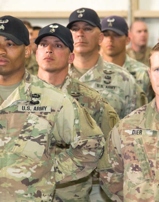 Army Staff Sgt. William Ramos, second from left, and Staff Sgt. Thomas Presutti, behind Ramos, both air assault instructors assigned to the Army National Guard Warrior Training Center, Fort Benning, Georgia, stand in formation with their graduating students Feb. 15, 2019, at Camp Buehring, Kuwait. Service members were offered an opportunity to attend the rigorous school to develop additional skills, including moving equipment and rappelling, while deployed in a combat environment. “You’re setting a Soldier up to be successful in a combat environment," said Ramos.