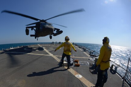 Aviators with the Minnesota, Texas and Utah National Guards, led by the Kansas National Guard’s 1st Battalion, 108th Aviation Regiment, practice landing and taking off during deck landing qualification training aboard the Arleigh Burke-class guided-missile destroyer USS Mitscher (DDG 57) in the Arabian Gulf on Feb. 4, 2019.
