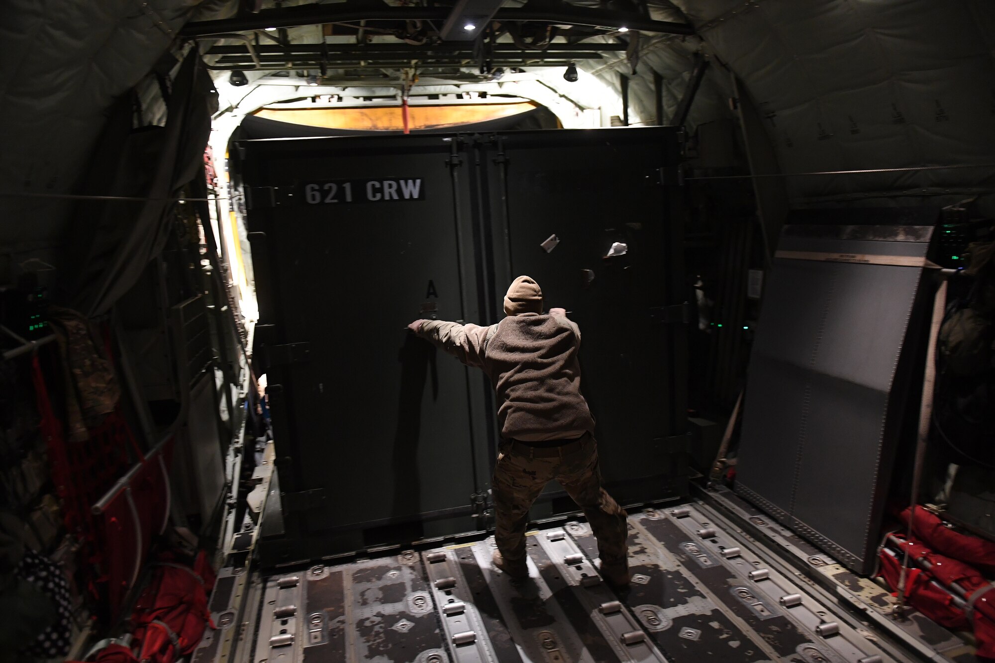 Staff Sgt Tyler Renteria, 41st Airlift Squadron loadmaster, secures a cargo container on a C-130 Hercules aircraft during Green Flag Little Rock exercise, Feb. 9, 2019, at the Joint Readiness Training Center, Fort Polk, La. The primary objective of the exercise is to support the Joint Readiness Training Center and provide the maximum number of airlift crews, mission planners and ground support elements to a simulated combat environment with emphasis on joint force integration. (U.S. Air Force photo by Tech. Sgt. Liliana Moreno)