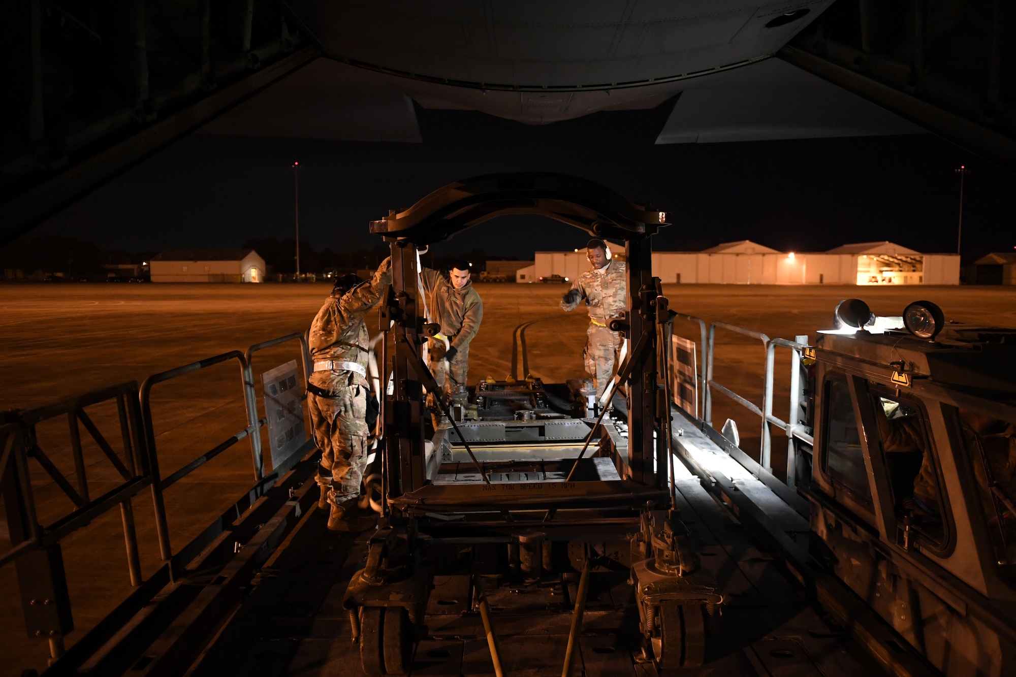 Aerial porters assigned to the 921st Contingency Response Squadron out of Travis Air Force Base, Calif., secure cargo onto a Halvorsen loader during a mission in support of Green Flag Little Rock exercise, Feb. 10, 2019, at the Alexandria International Airport, La. The primary objective of the exercise is to support the Joint Readiness Training Center and provide the maximum number of airlift crews, mission planners and ground support elements to a simulated combat environment with emphasis on joint force integration. (U.S. Air Force photo by Tech. Sgt. Liliana Moreno)