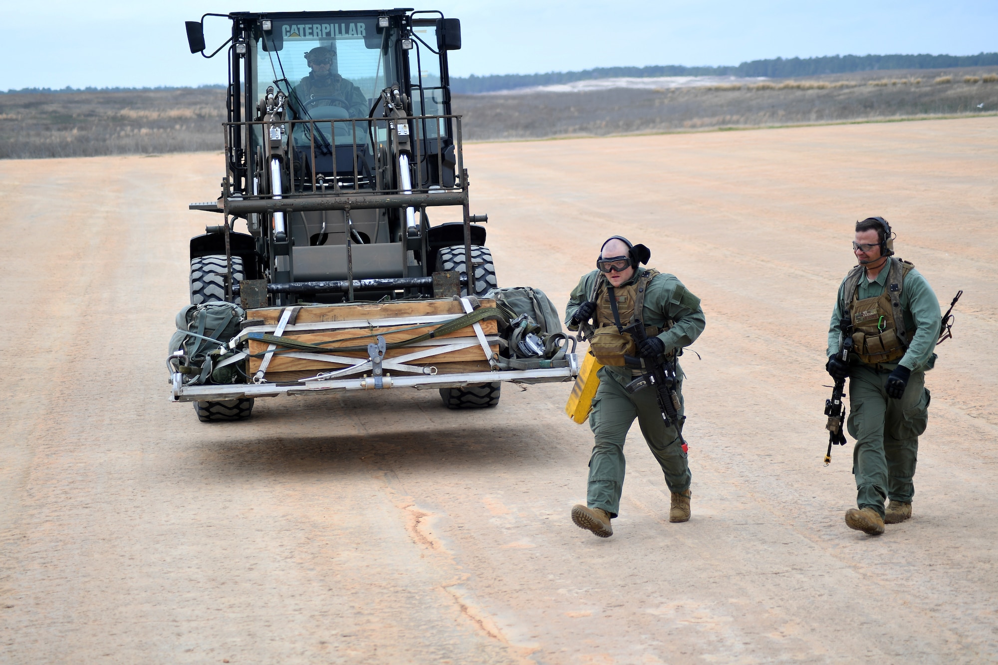 Aerial porters assigned to the 921st Contingency Response Squadron out of Travis Air Force Base, Calif., prepare to load cargo into a C-130 Hercules aircraft during a mission in support of Green Flag Little Rock exercise, Feb. 11, 2019, Fort Polk, La. The primary objective of the exercise is to support the Joint Readiness Training Center and provide the maximum number of airlift crews, mission planners and ground support elements to a simulated combat environment with emphasis on joint force integration. (U.S. Air Force photo by Tech. Sgt. Liliana Moreno)