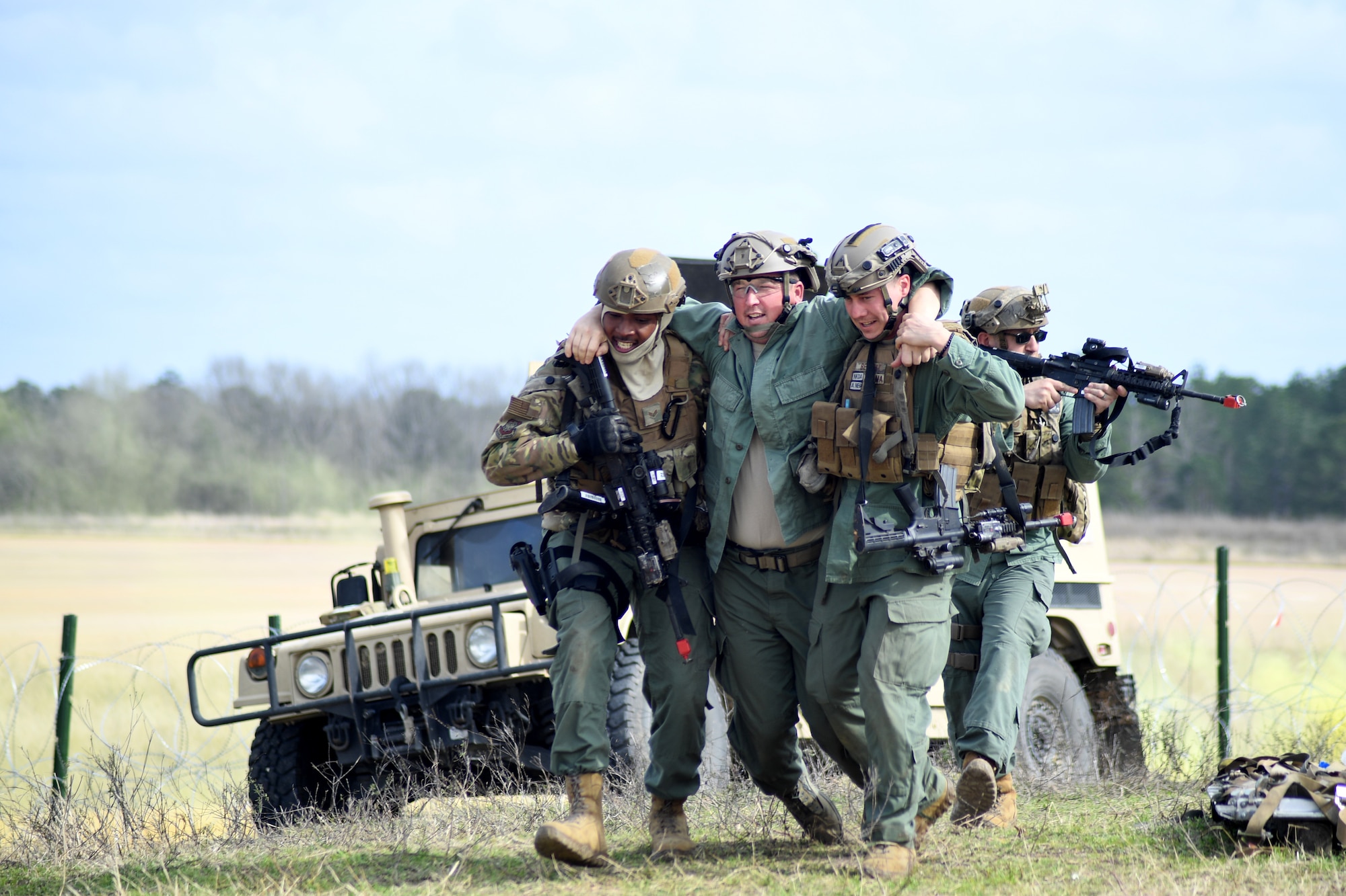 Contingency Response Forces assigned to the 821st Contingency Response Group out of Travis Air Force Base, Calif., assist a wounded victim during a simulated gunfire attack at the Geronimo Landing Zone during a mission in support of Green Flag Little Rock exercise, Feb. 14, 2019, Fort Polk, La. The primary objective of the exercise is to support the Joint Readiness Training Center and provide the maximum number of airlift crews, mission planners and ground support elements to a simulated combat environment with emphasis on joint force integration. (U.S. Air Force photo by Tech. Sgt. Liliana Moreno)