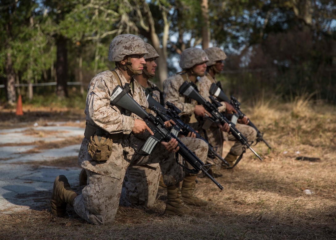 Michael Campofiori, a recruit with Platoon 2020, Company E, 2nd Recruit Training Battalion, Recruit Training Regiment, and his fellow recruits await the command to begin the Day Movement Course as part of Basic Warrior Training at Marine Corps Recruit Depot Parris Island, South Carolina, Feb. 6, 2019. Campofiori, a native of Brick Township, New Jersey, overcame Leukemia and is now pursuing a career in the Marine Corps. BWT is a week-long training event that helps teach recruits the basics of combat survival and advanced rifle maneuvers. (U.S. Marine Corps photo by Lance Cpl. Jack A. E. Rigsby)